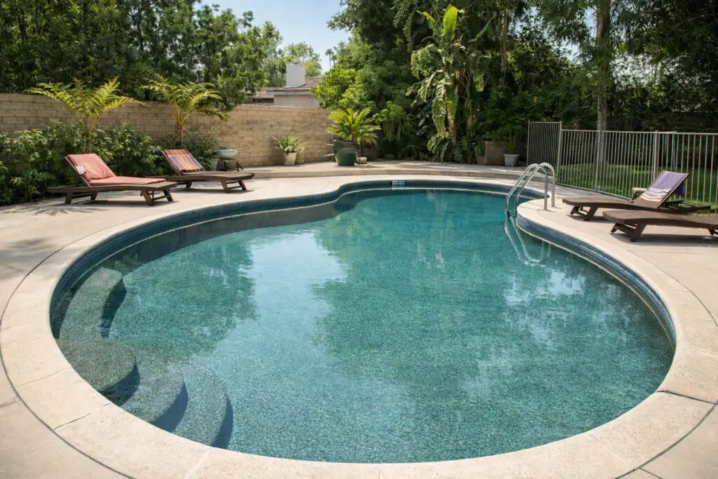 Swimming pool and lounge chairs at Aura House women's sober living